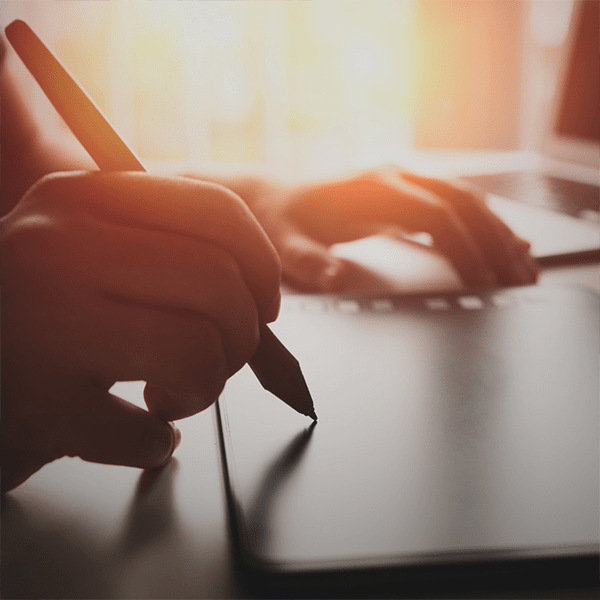 A hand holding a pen to write