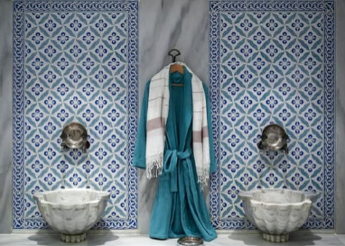 A Hammam in Morocco. The image shows a bath robe hanging on a titled wall.